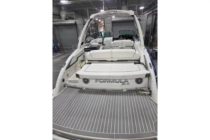 Slide: The Image of 2019 Formula 310 Sun Sport boat interior with seating and deck view. - 12