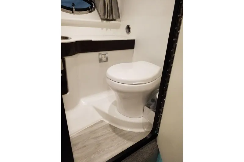 Slide: The Image of 2019 Formula 310 Sun Sport boat bathroom with modern toilet and sleek design. - 17