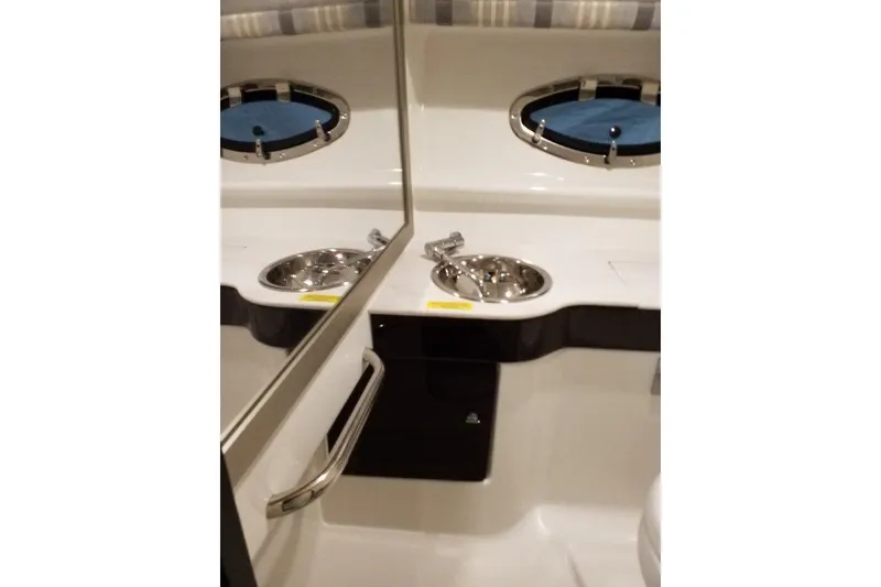 Slide: The Image of 2019 Formula 310 Sun Sport boat interior with sink and porthole window. - 18