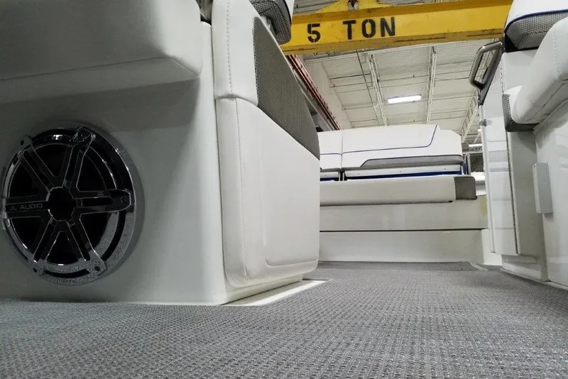 Slide: The Image of 2019 Formula 310 Sun Sport interior with JL Audio speaker and cushioned seating. - 20