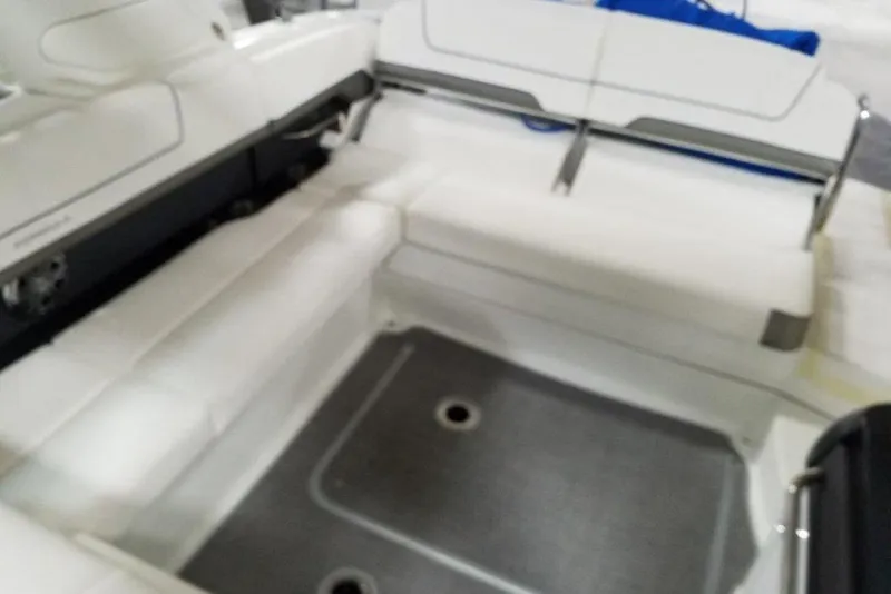 Slide: The Image of 2019 Formula 310 Sun Sport boat interior with white seating and gray flooring. - 23