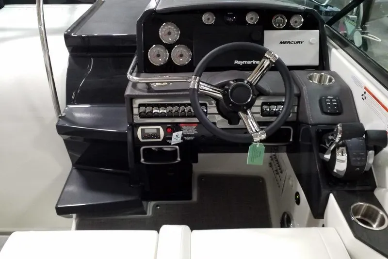 Slide: The Image of 2019 Formula 310 Sun Sport boat dashboard with steering wheel and control panel. - 24