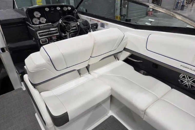 Slide: The Image of 2019 Formula 310 Sun Sport boat interior with white seating and modern dashboard. - 6