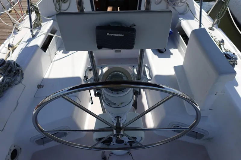 Slide: The Image of Steering wheel and cockpit of a 1997 Catalina 28 sailboat with navigation equipment. - 10