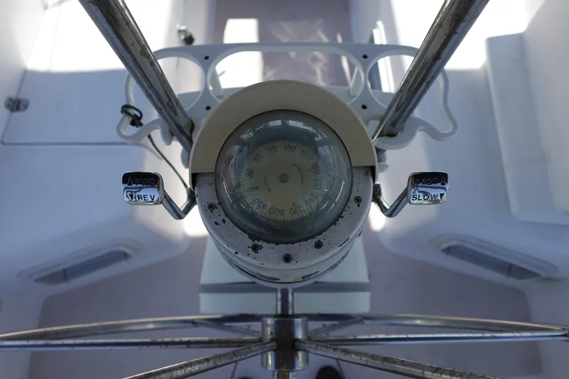 Slide: The Image of Steering wheel and compass of a 1997 Catalina 28 sailboat cockpit. - 13