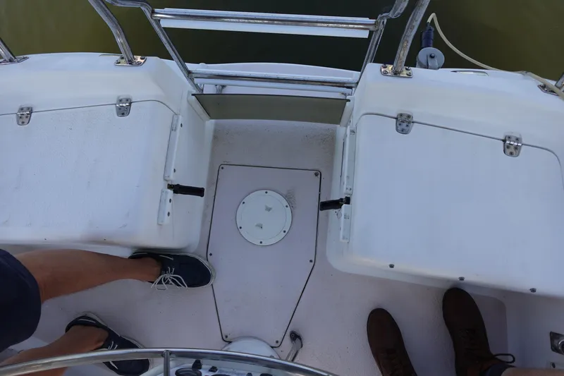 Slide: The Image of Cockpit view of a 1997 Catalina 28 sailboat with visible seating and railing. - 18