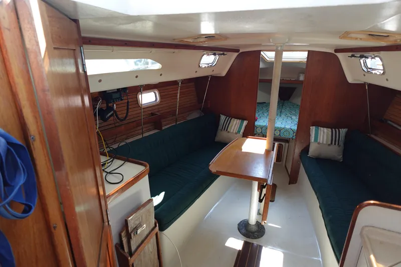 Slide: The Image of Interior of a 1997 Catalina 28 sailboat with cozy seating and wooden finishes. - 21