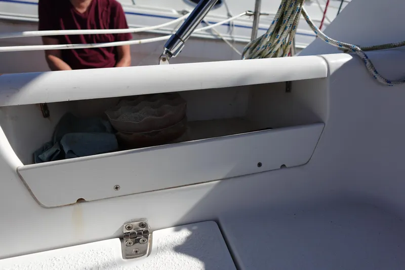Slide: The Image of Open storage compartment on 1997 Catalina 28 sailboat with ropes and items inside. - 25