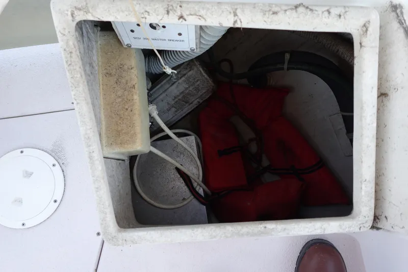 Slide: The Image of Storage compartment on a 1997 Catalina 28 boat with life jackets and electrical components. - 26