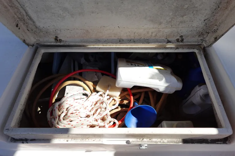 Slide: The Image of Storage compartment on a 1997 Catalina 28 sailboat with ropes and equipment. - 28