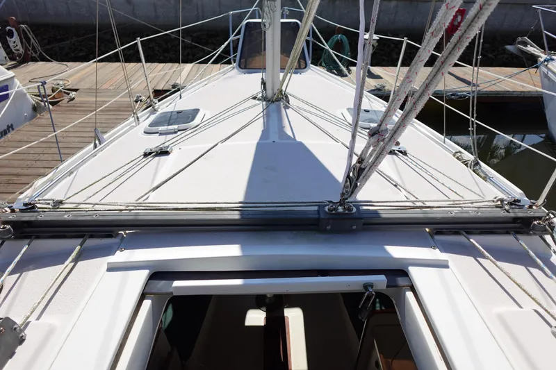 Slide: The Image of Deck view of a 1997 Catalina 28 sailboat docked at a marina. - 31