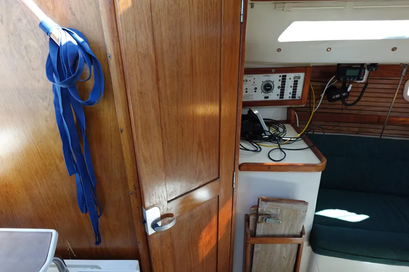 Slide: The Image of Interior of a 1997 Catalina 28 sailboat with wooden paneling and navigation equipment. - 33