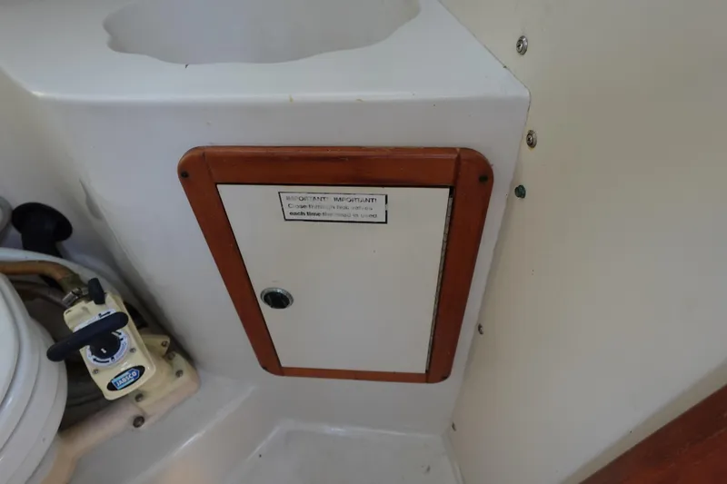 Slide: The Image of Interior of a 1997 Catalina 28 sailboat showing a small storage compartment. - 35