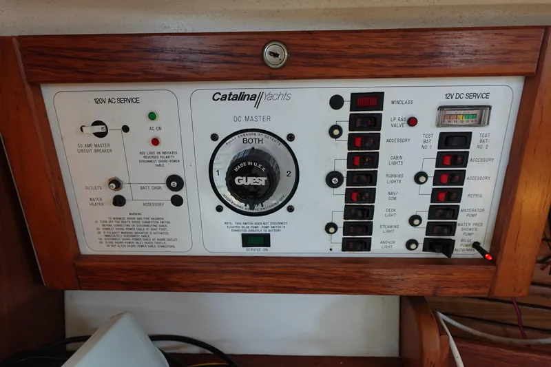 Slide: The Image of Control panel of a 1997 Catalina 28 yacht with various switches and indicators. - 38
