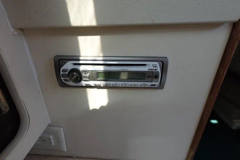 Slide: The Image of 1997 Catalina 28 interior with a Sony car stereo installed on a white panel. - 47