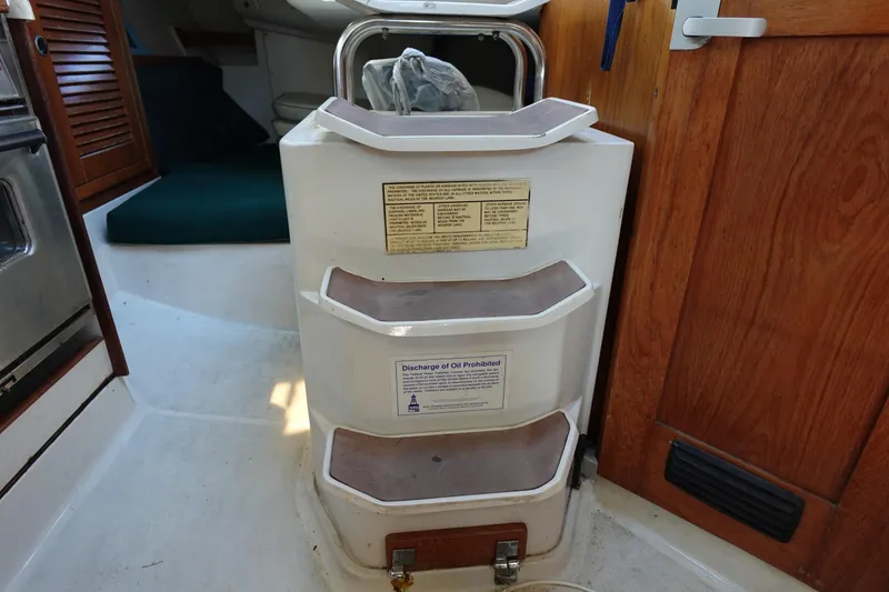 Slide: The Image of Interior steps of a 1997 Catalina 28 sailboat with wooden accents. - 48