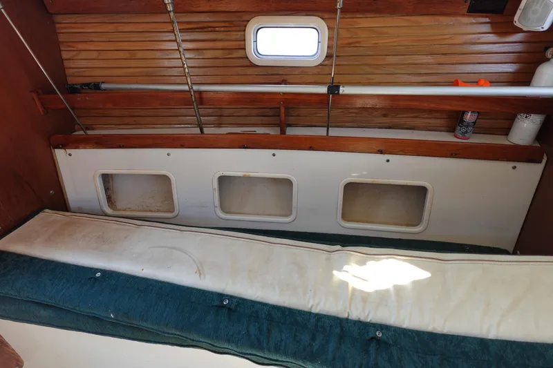 Slide: The Image of Interior of a 1997 Catalina 28 sailboat with wooden paneling and storage compartments. - 50