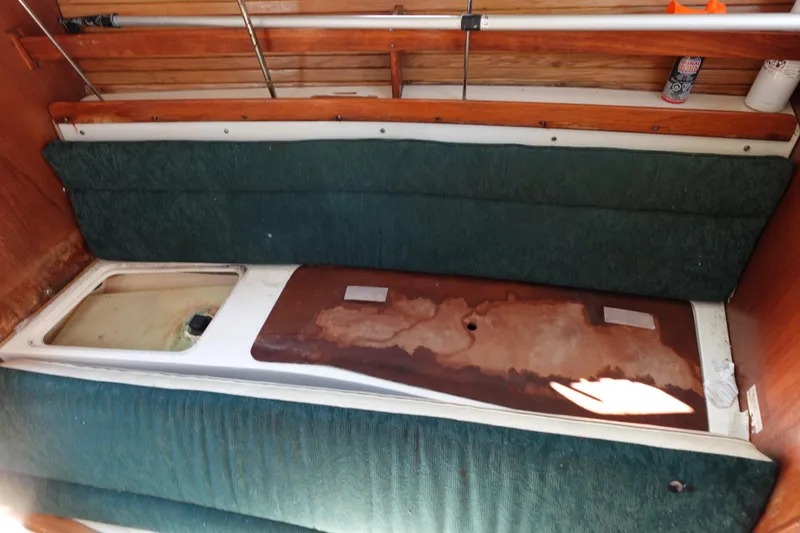 Slide: The Image of Interior of a 1997 Catalina 28 sailboat with green cushions and wooden accents. - 51