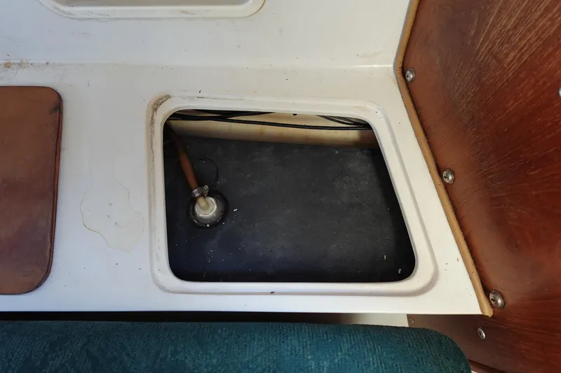 Slide: The Image of Open compartment in 1997 Catalina 28 sailboat interior, showing plumbing and storage area. - 54