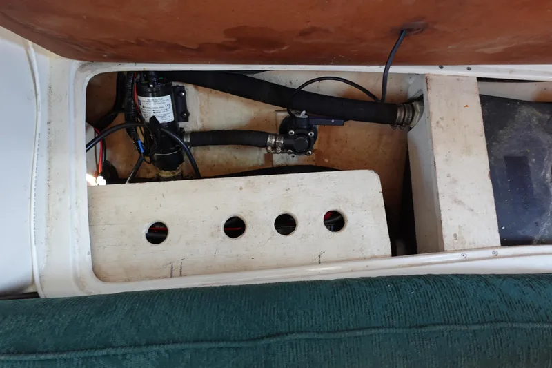 Slide: The Image of 1997 Catalina 28 boat interior showing mechanical components and wiring. - 55