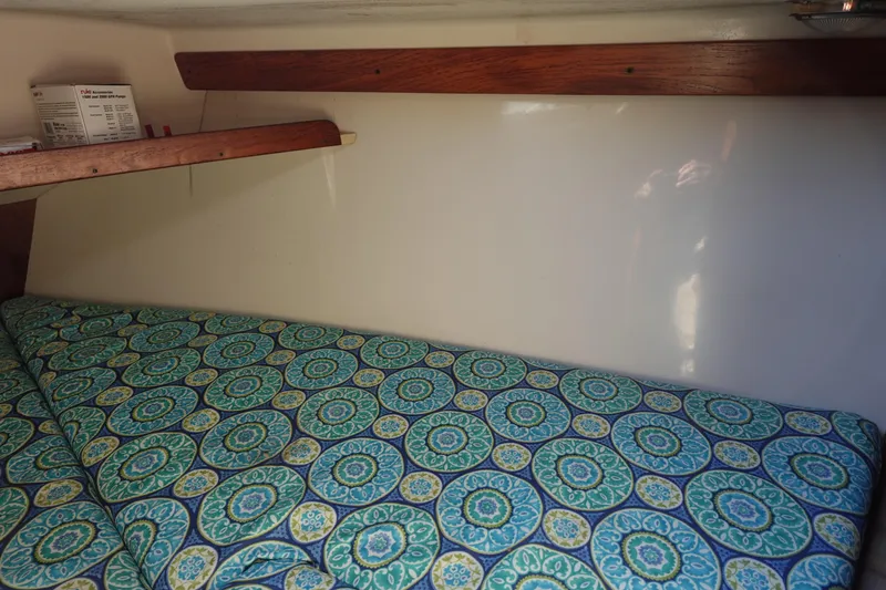 Slide: The Image of Cozy cabin interior of 1997 Catalina 28 sailboat with patterned bedding. - 58