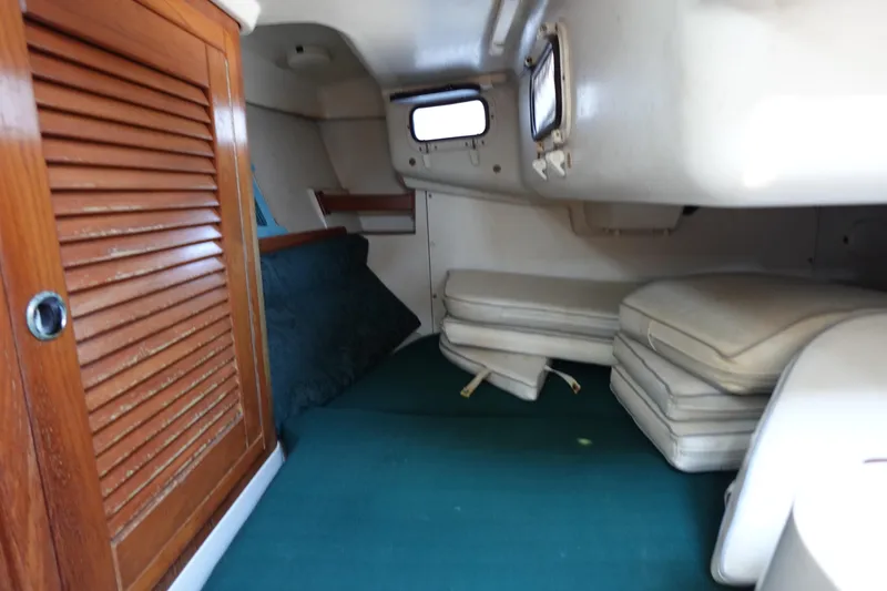 Slide: The Image of Interior cabin of a 1997 Catalina 28 sailboat with wooden door and cushions. - 6