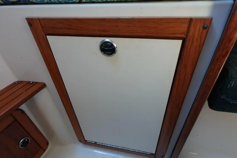 Slide: The Image of Wood-trimmed cabinet door on a 1997 Catalina 28 sailboat interior. - 61