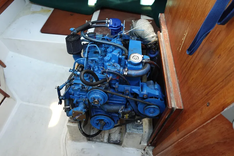 Slide: The Image of Engine of a 1997 Catalina 28 sailboat, painted blue, in a wooden compartment. - 65