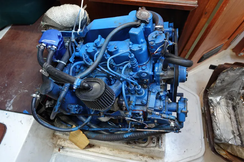 Slide: The Image of Engine of a 1997 Catalina 28 sailboat, painted blue, with visible hoses and components. - 66
