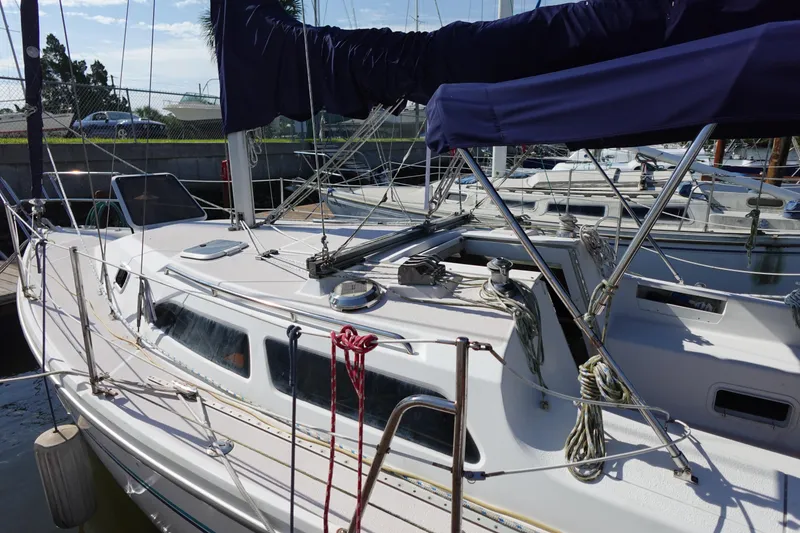 Slide: The Image of 1997 Catalina 28 sailboat docked, featuring a sleek design and well-maintained deck. - 7