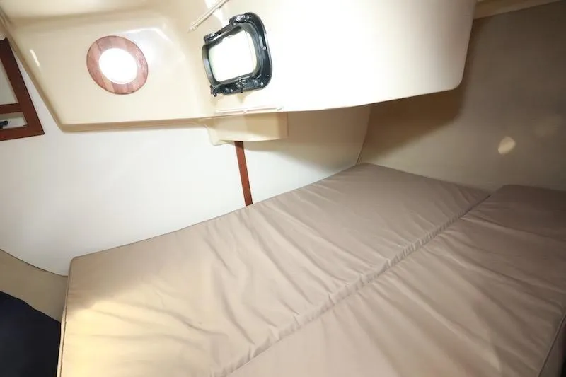 Slide: The Image of Interior cabin of a 1989 Hunter 30 sailboat with a bed and porthole. - 14