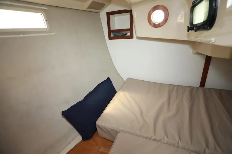 Slide: The Image of Cozy cabin interior of 1989 Hunter 30 sailboat with cushions and porthole. - 15