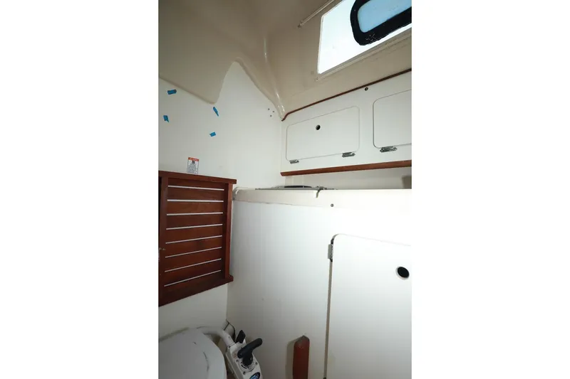 Slide: The Image of Interior of 1989 Hunter 30 sailboat bathroom with wooden accents and storage cabinets. - 18