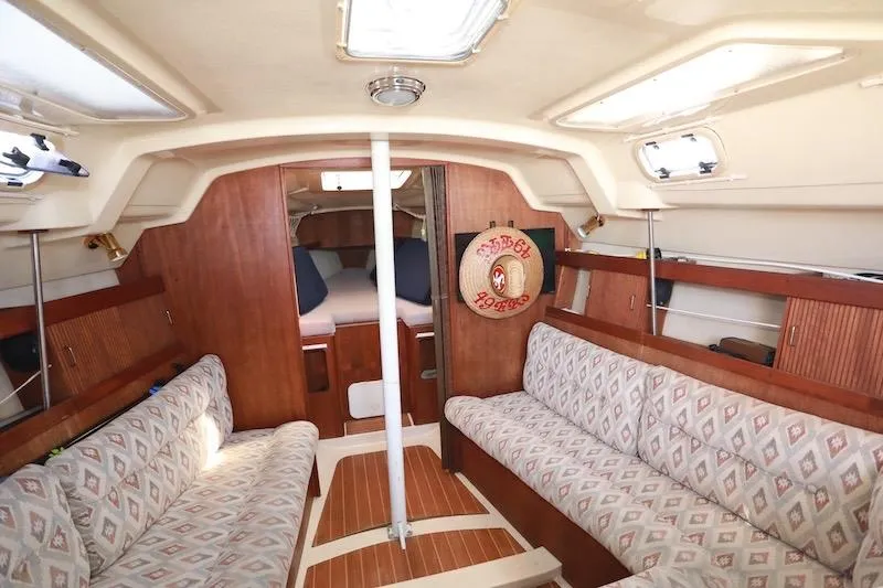 Slide: The Image of Interior of a 1989 Hunter 30 sailboat with cozy seating and wooden finishes. - 5
