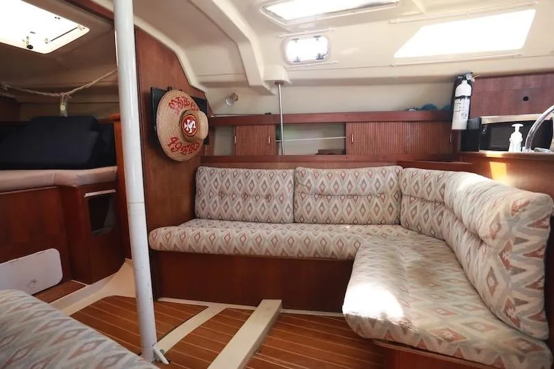 Slide: The Image of Interior of 1989 Hunter 30 sailboat with patterned seating and wooden accents. - 6