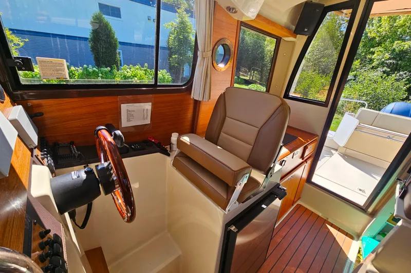 Slide: The Image of Interior of 2021 Ranger Tugs R-23 boat with steering wheel and captain's chair. - 10