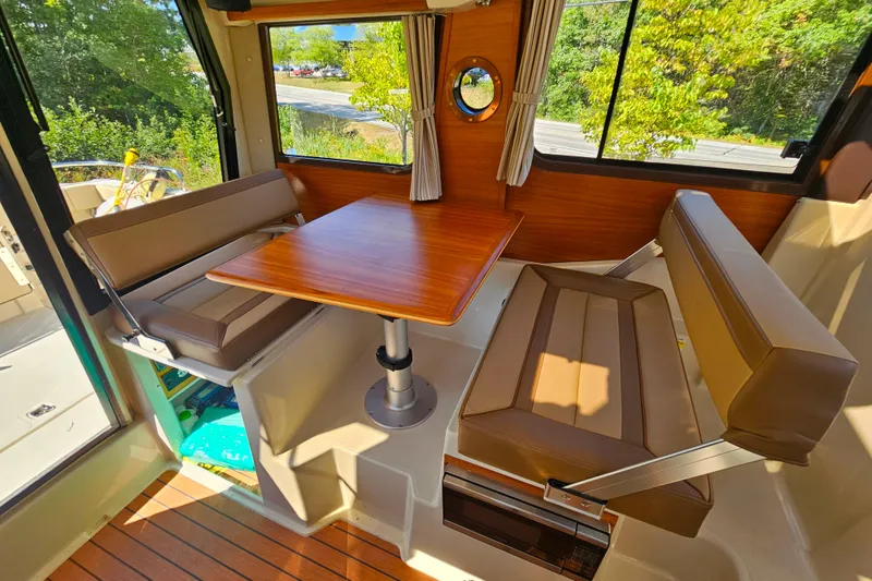 Slide: The Image of Interior of 2021 Ranger Tugs R-23 boat with cozy dining area and wooden table. - 19