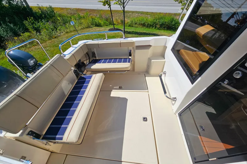Slide: The Image of 2021 Ranger Tugs R-23 boat interior with cushioned seating and sleek design. - 8