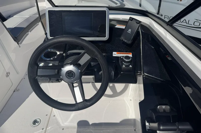 Slide: The Image of 2025 Yamaha Boats SX250 helm with steering wheel and digital display. - 15