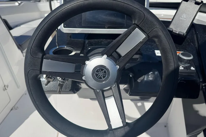 Slide: The Image of Steering wheel of 2025 Yamaha Boats SX250, featuring sleek design and modern controls. - 18