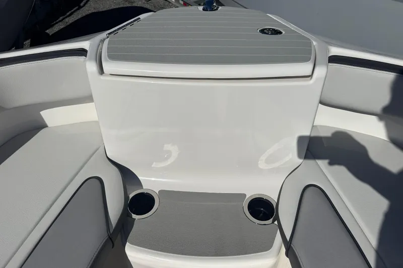 Slide: The Image of Interior view of 2025 Yamaha Boats SX250, featuring seating and cup holders. - 6