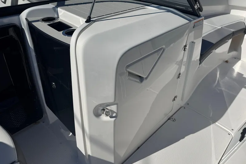 Slide: The Image of 2025 Yamaha Boats SX250 interior with storage compartment and seating area. - 9