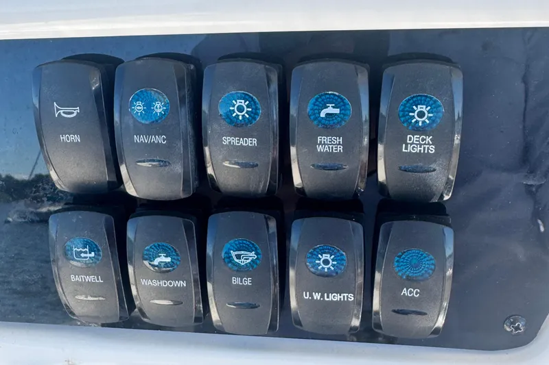 Slide: The Image of Control panel of 2024 Sailfish 241 CC boat with labeled switches. - 18
