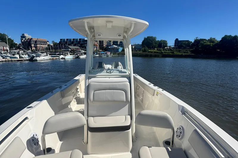 Slide: The Image of 2024 Sailfish 241 CC boat on water, featuring spacious seating and modern design. - 5