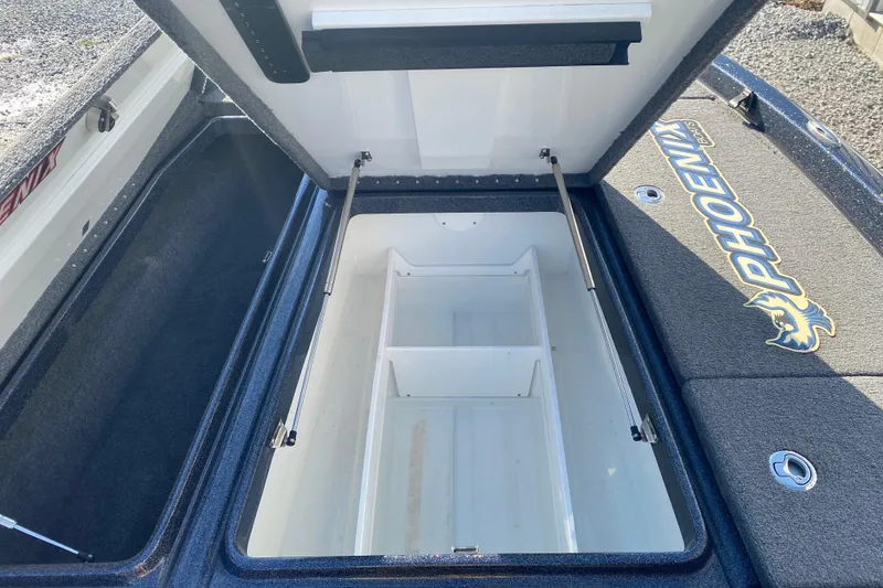 Slide: The Image of Open storage compartment in 2022 Phoenix 920 Elite boat, showcasing spacious interior. - 16