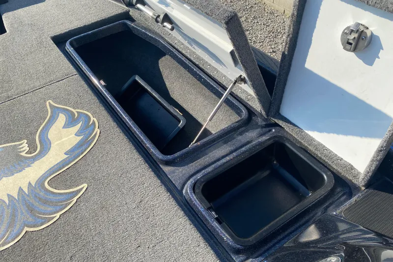 Slide: The Image of Phoenix 920 Elite 2022 boat storage compartments with open lids and logo detail. - 17