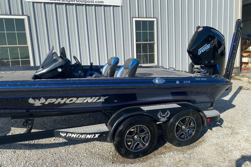 Slide: The Image of 2022 Phoenix 920 Elite boat with Mercury Pro XS engine, parked outside a building. - 6