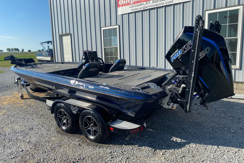 Slide: The Image of 2022 Phoenix 920 Elite boat with Mercury Pro XS engine, parked outside a building. - 7