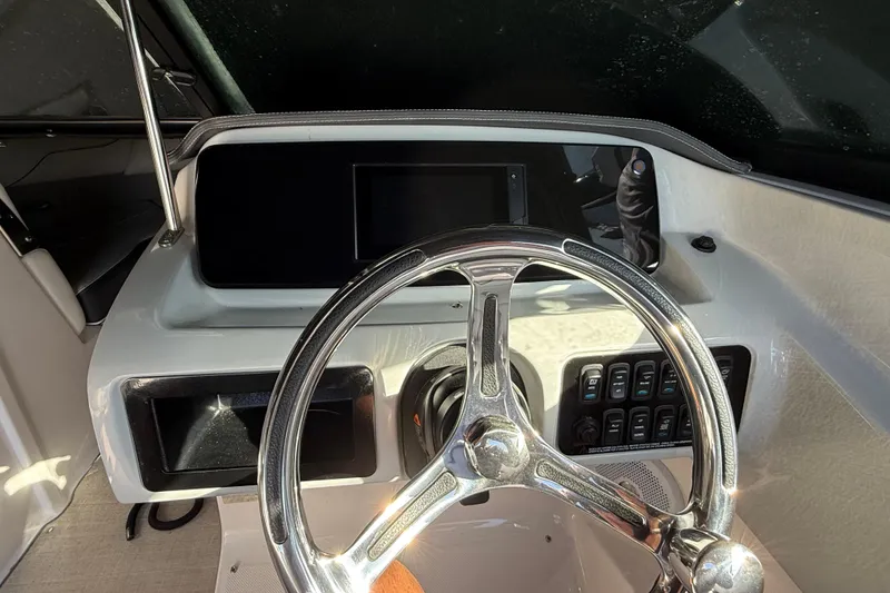 Slide: The Image of 2021 Regal LX2 boat dashboard with steering wheel and control panel. - 5