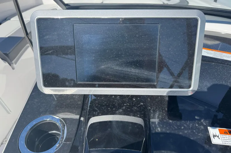 Slide: The Image of Dashboard of 2025 Yamaha Boats SX250 with touchscreen display and cup holder. - 17
